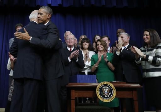 President Barack Obama embraces Vice President Joe Biden after signing the 21st Century Cures Act, Tuesday, Dec. 13, 2016, in the South Court Auditorium in the Eisenhower Executive Office Building on the White House complex in Washington. (AP Photo/Carolyn Kaster)