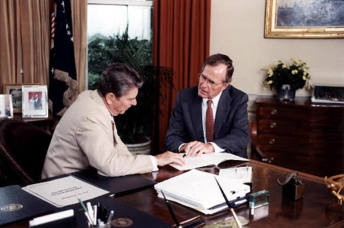 Bush and Reagan corroborating in 1984. (Wikimedia Commons)